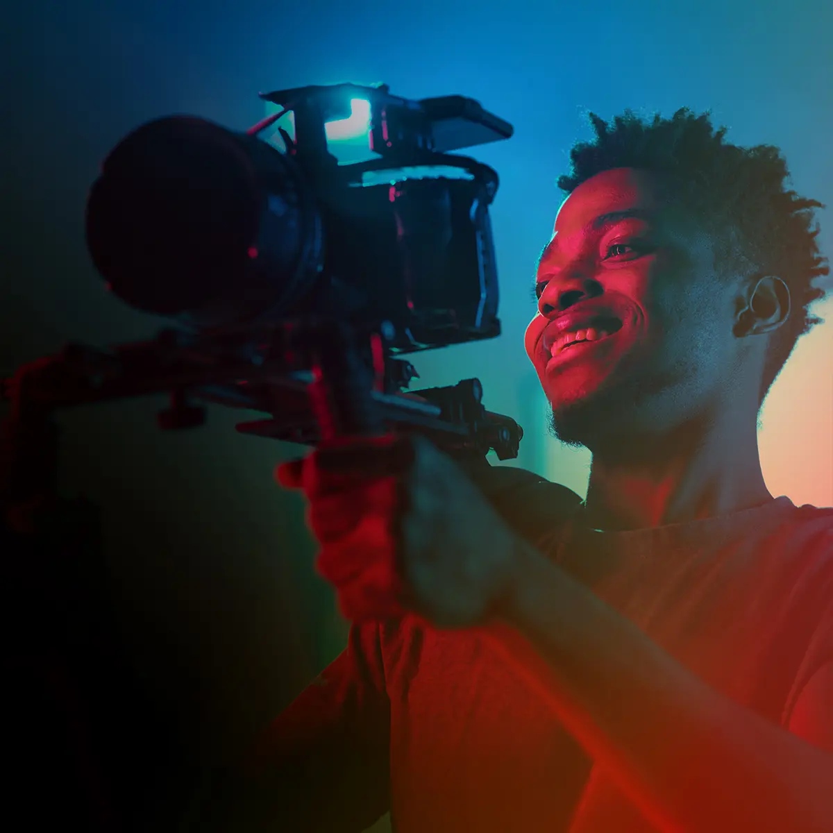 Closeup of a young man operating a television camera